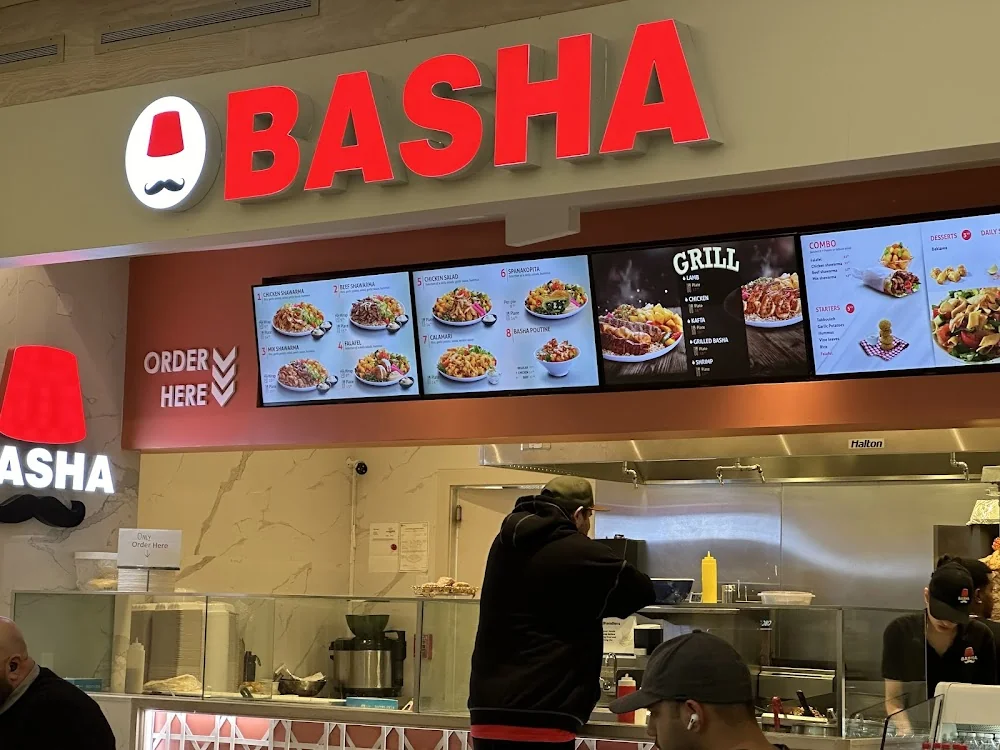 Basha restaurant menu board showing chicken shawarma poutine and grill items, basha menu prices canada